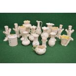 Group of eighteen pieces of Belleek porcelain to include: four tree formed spill vases, two jugs,