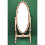 Cream and gilt painted cheval mirror having oval mirror supported on outward tapering reeded columns