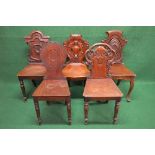 Group of five 19th century mahogany hall chairs each having shaped back over solid seat, standing on