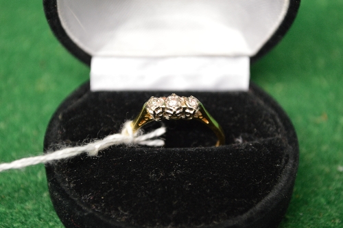 18ct gold ladies ring set with a row of three small diamonds (gross weight 2.8gms) Please note