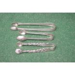 Three pairs of silver sugar tongs, two marked for London the other having a Georgian hallmark Please