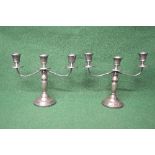 Pair of two branch silver candelabra's having fluted sconces and standing on circular footed