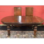 Mahogany wind out dining table the top having rounded ends and moulded edge, standing on bulbous