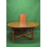 20th century oak extending dining table the top having D shaped ends supported on turned columns