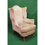 Wingback upholstered armchair having scrolled arms with removable seat cushion and bow front,