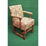 Oak upholstered armchair having padded back and arms with removable seat cushion and standing on