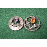Two Sterling Silver Scottish thistle brooches one set with amethyst and the other with orange