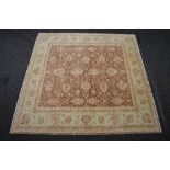 Beige ground rug having brown, red and pink pattern - approx 2.09m x 2.09m Please note