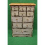 Distressed painted bank of pine drawers having six small drawers over four further drawers and