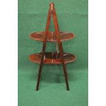Mahogany folding two tier cake stand of pyramid form having four cake shelves, standing on square