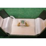 18ct yellow gold ladies ring having single rectangular emerald surmounted by a series of small