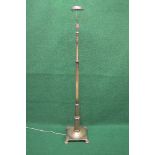 Adjustable metal standard lamp having a square base and standing on four stepped bracket style