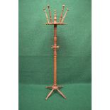Oak free standing coat stand having turned hat and coat hooks supported on a central turned column