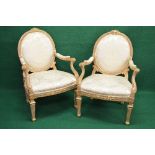 Pair of giltwood open armchairs having padded backs and arms over bow fronted seats and standing