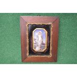 Framed miniature painting of a semi nude woman standing on a rock at sea with a gilt card mount