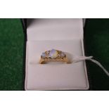 18ct yellow gold ladies ring set with central opal flanked by two small diamonds and further