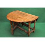 20th century oval drop flap dining table having bow ends and supported on stretchered block and