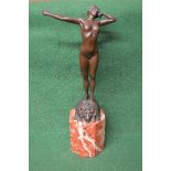 Unsigned bronze figure of a nude stretching lady standing on a recumbent lion on a tall octagonal