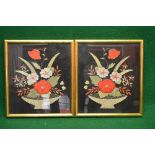 Pair of floral needleworks of flowers in baskets on a black background, in glazed gilt frames -