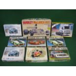 Nine unmade plastic racing car and DAF truck kits by Tamiya, Italeri, Bandai and Heller, all 1:24