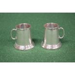 Pair of sterling silver miniature tankards having glass bottoms, bearing the makers initials JB