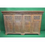 Oak carved four door cupboard having carved and fielded panelled doors opening to reveal three fixed