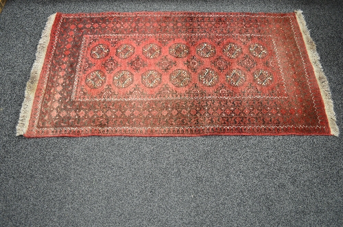 Red ground rug having white and black pattern with end tassels - 1.92m x 1.02m Please note