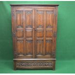 20th century oak linen fold two door wardrobe each door having six panels opening to reveal