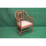 Faux bamboo tub style armchair the back having chinoiserie painted panel over a padded seat,