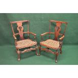 Pair of open elbow chairs having pierced back splat over a cane work seat, standing on stretchered