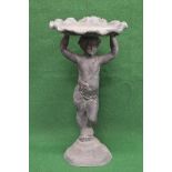 Lead birdbath having shell top supported by a figure of a standing cherub, standing on a shaped