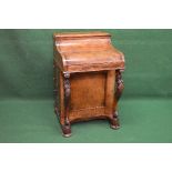 19th century walnut Davenport desk the top opening to reveal fitted interior and supported on carved