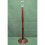 19th century mahogany standard lamp having turned column leading to a circular base Please note