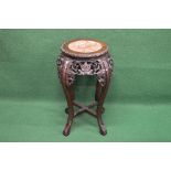Oriental hardwood plant stand having circular marble insert over a pierced carved frieze, standing