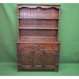 Oak dresser the top having shaped frieze over two fixed shelves the base having two drawers over two
