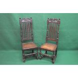 Pair of oak high back hall chairs having pierced top rails over moulded vertical slats and turned