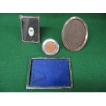 Group of four silver photograph frames of rectangular, oval and circular shape, marked for