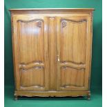 20th century walnut armoire having two panelled doors opening to reveal hanging space and shelves,