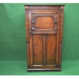 20th century oak hall robe having single three panelled door with carved decoration opening to