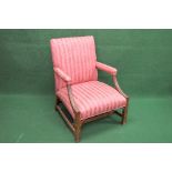 Mahogany framed open armchair having padded back, seat and arms with carved supports leading to