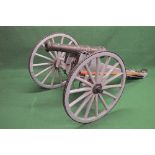 Replica two wheeled carriage cannon having fibreglass cannon barrel on a painted wooden carriage and