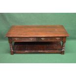 20th century oak coffee table having two drawers and supported on turned legs leading to a lower