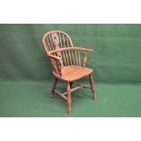 Elm comb back Windsor chair having pierced back splat and spindles over a solid seat, standing on