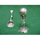 White metal pepper pot in the form of a young boy holding a ball above his head, standing on a