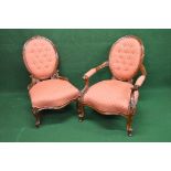 Pair of Victorian button back chairs having oval backs over overstuffed seats with serpentine