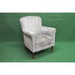 Upholstered tub style armchair having padded back and arms and overstuffed seat, standing on