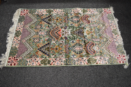 Silk green ground rug having decoration of blues, pinks and greens with end tassels - 2.09m x 1.