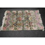 Silk green ground rug having decoration of blues, pinks and greens with end tassels - 2.09m x 1.