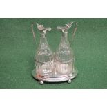 Pair of glass ewers having white metal tops and standing on silver stand with ball feet, marked