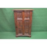 Oak side cabinet having two panelled doors each door having two panels opening to reveal three fixed